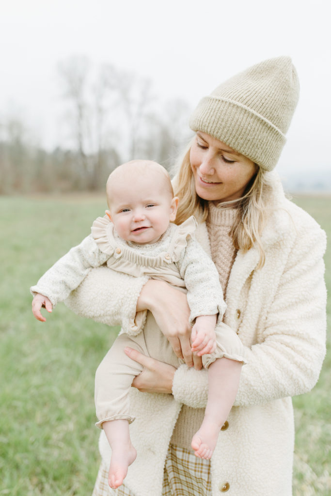 mother and baby wearing neutral colors in portland for a family session