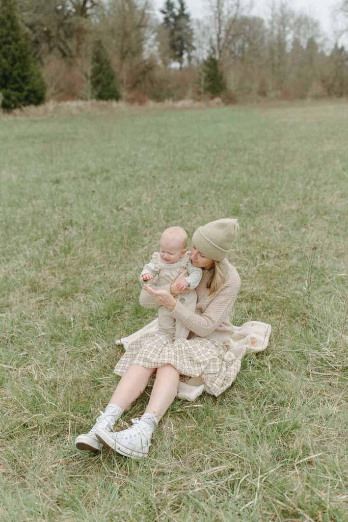mother and baby wearing neutral colors in portland for a family session