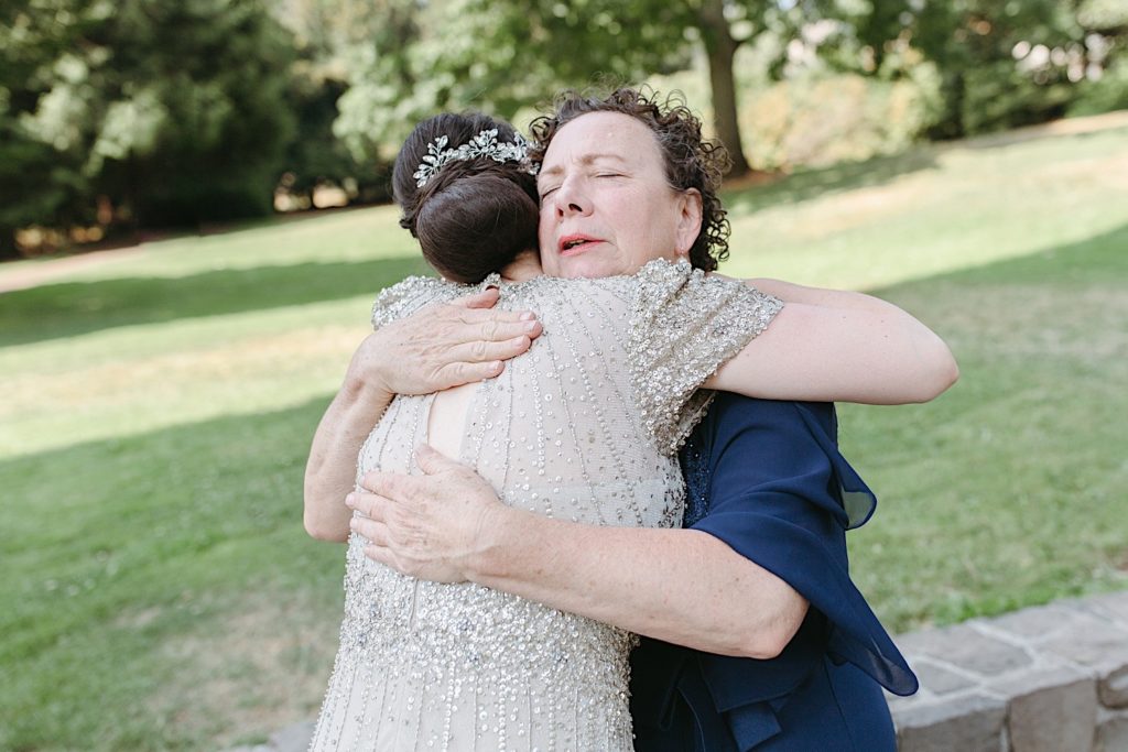 mother and mother of the bride hugging