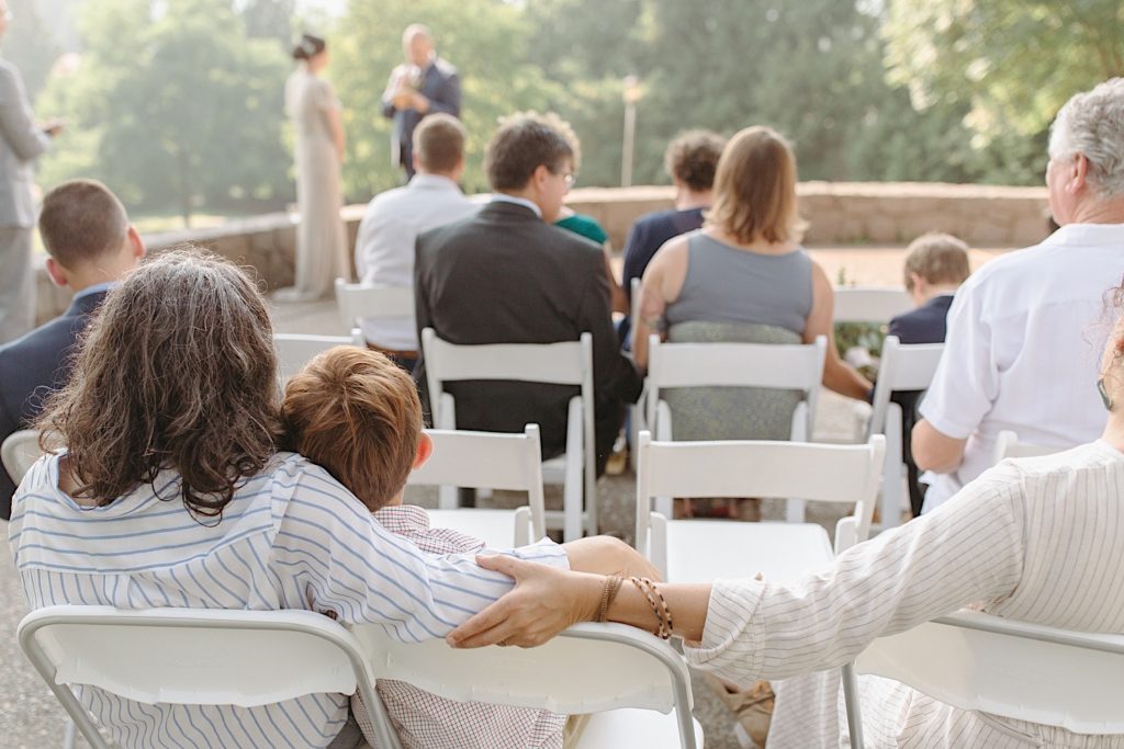 guest holding each other at cathedral park wedding ceremony