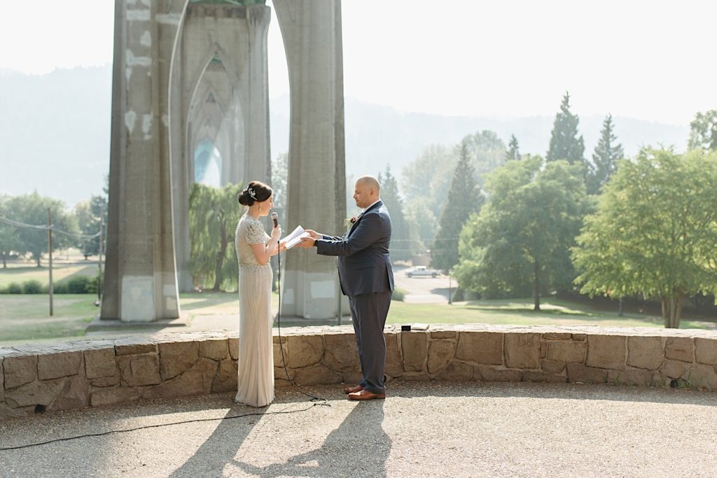 bride and groom reading vows during cathedral park wedding