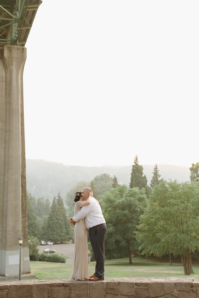 bride and groom hugging at cathedral park